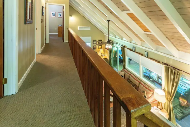 Hallway on upper level. First room two sets of bunks