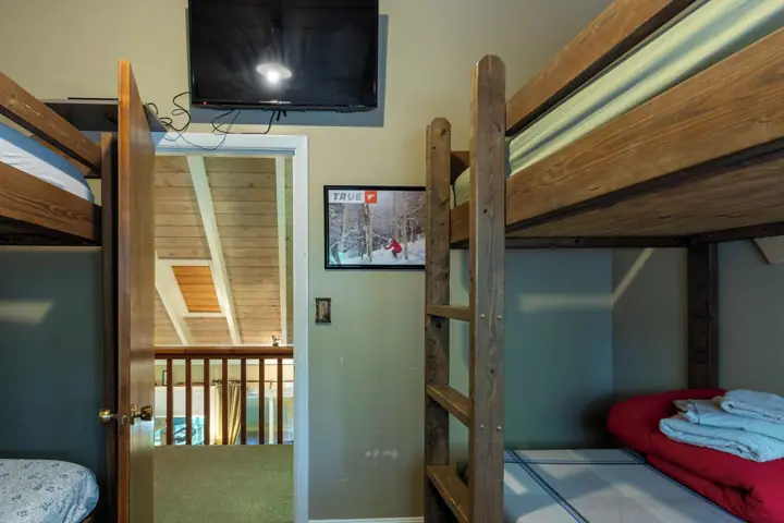 Upper bunkroom two sets of bunks with streaming TV