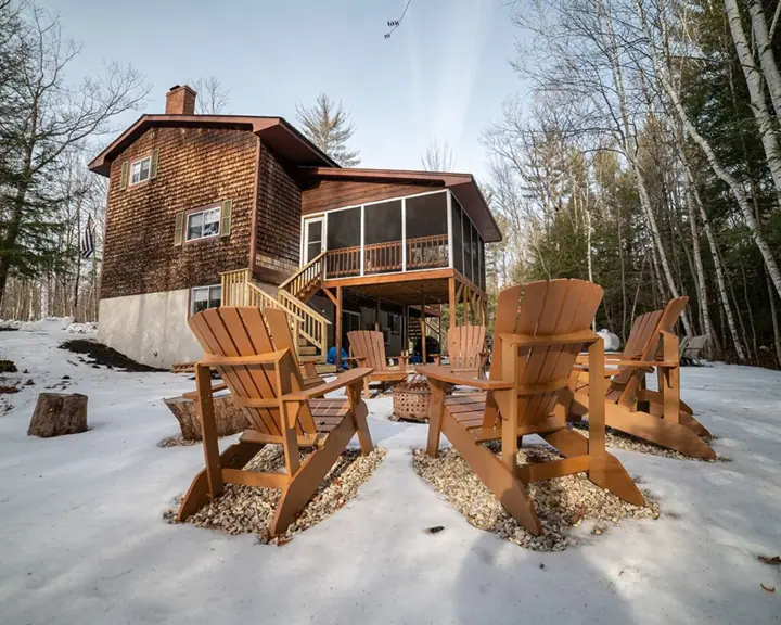 Back of house with new Adirondack chairs and firepit