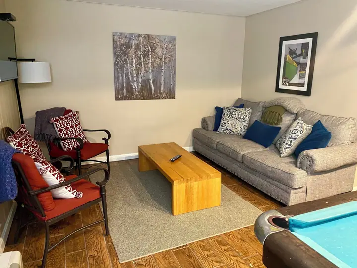 Sitting area by pool table lower level with TV