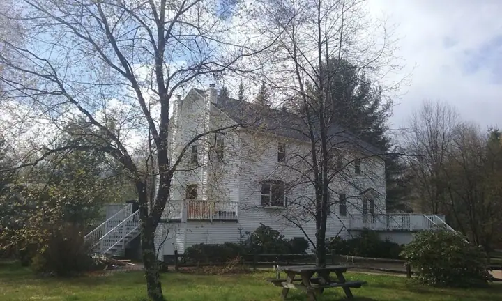 A large, historic building with a prominent tower and a staircase leading to the entrance